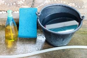 Bucket of water, sponge and cleaning fluid.