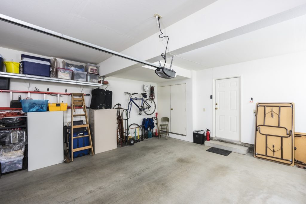 Inside a tidy garage with white walls & concrete flooring