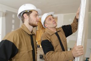 Constructor and apprentice verifies correct installation on gara